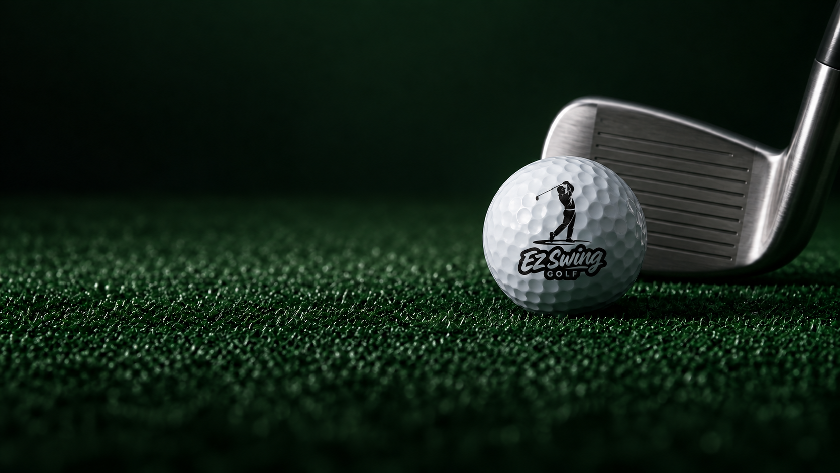EZ Swing Golf branded golf ball and iron on deep green turf